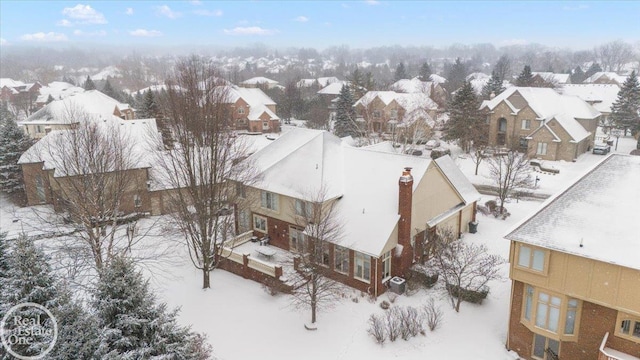 snowy aerial view with a residential view