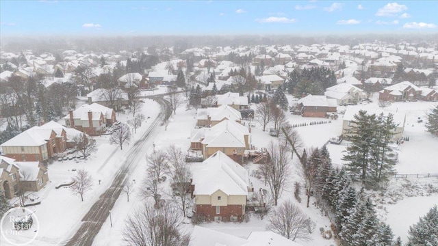 snowy aerial view featuring a residential view