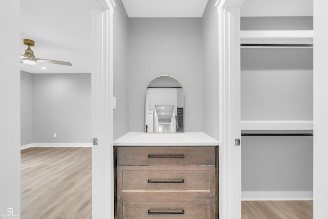 spacious closet with light wood-type flooring and ceiling fan