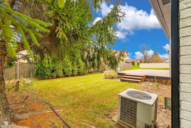 view of yard with cooling unit and a deck