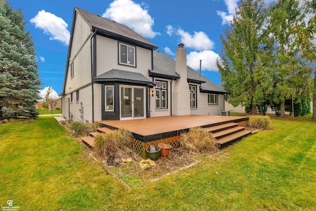 back of house with a deck and a lawn