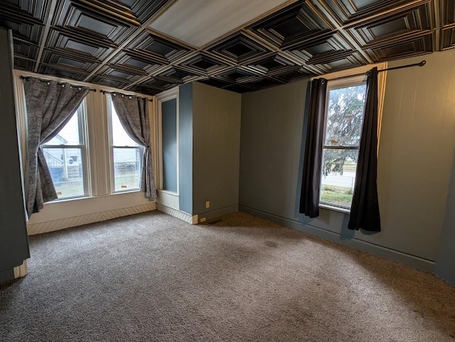 spare room featuring carpet and a wealth of natural light