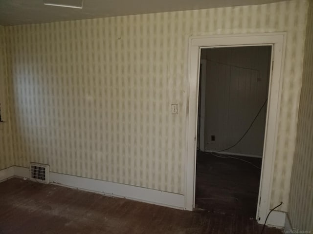 spare room featuring wood-type flooring