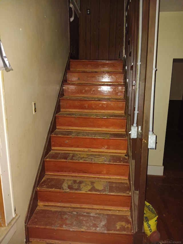 stairway with hardwood / wood-style floors