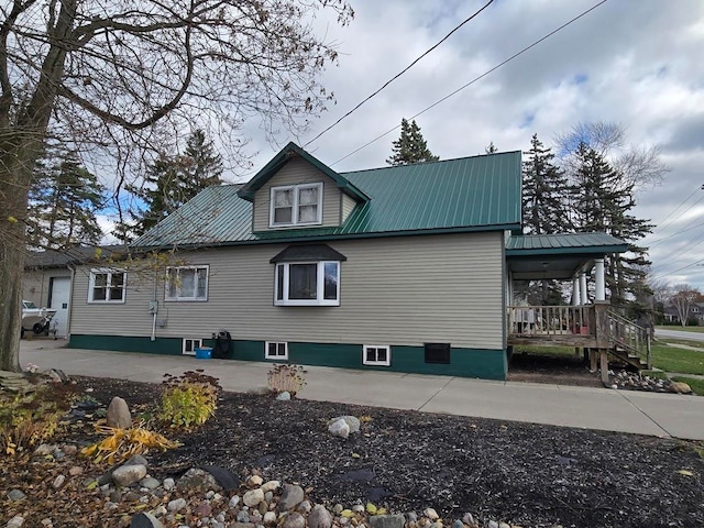 view of side of property featuring covered porch