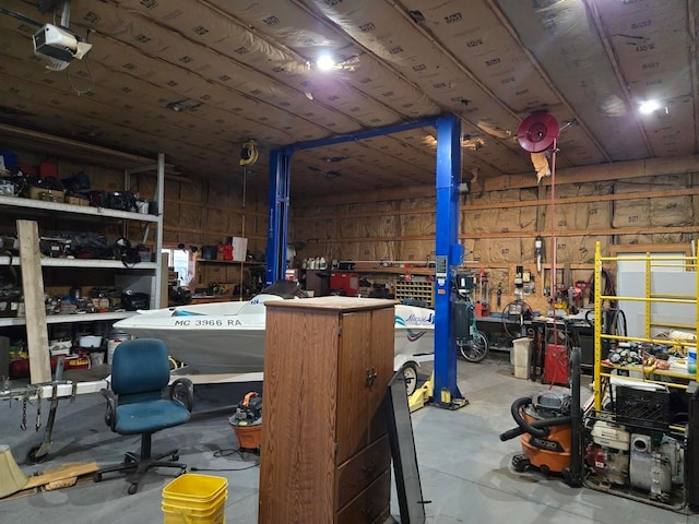 garage with a workshop area, wooden walls, and a garage door opener