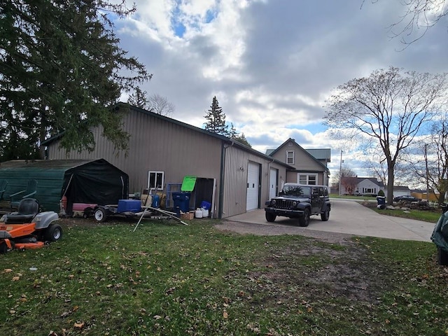 view of home's exterior with a yard and a garage