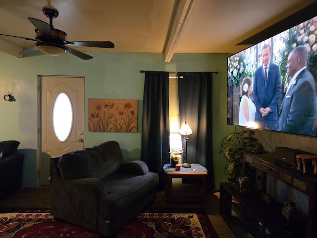 living room featuring beam ceiling, ceiling fan, and dark wood-type flooring