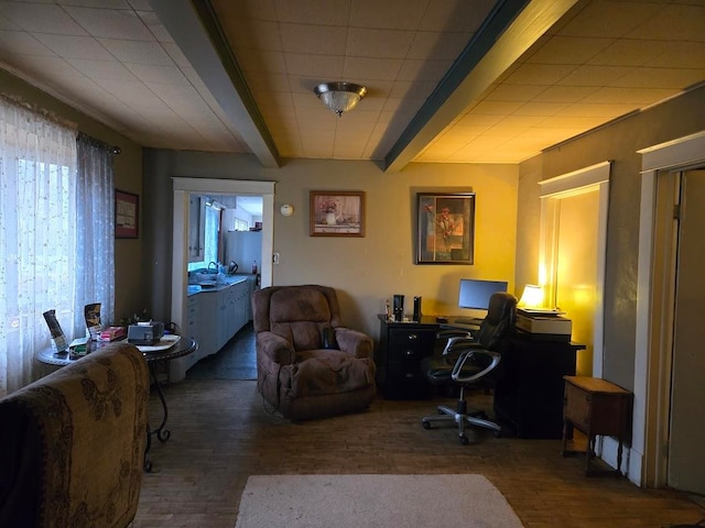 office featuring beamed ceiling, dark hardwood / wood-style flooring, and sink