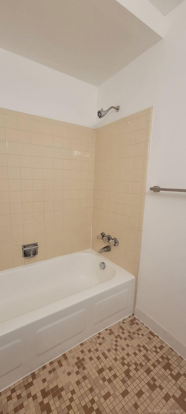 bathroom featuring tile patterned flooring and tiled shower / bath combo