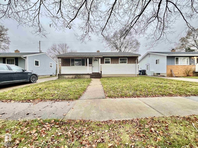 view of front of home featuring central AC and a front lawn