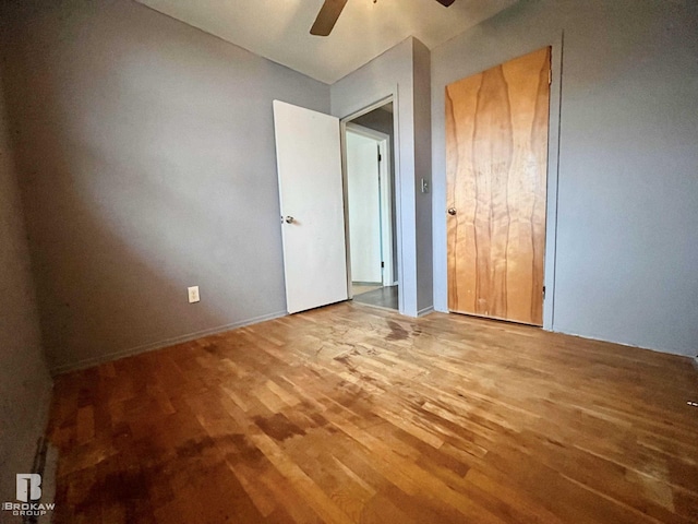 unfurnished bedroom with hardwood / wood-style floors and ceiling fan