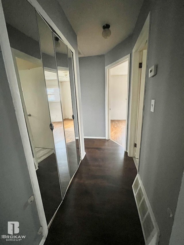 corridor with dark wood-type flooring