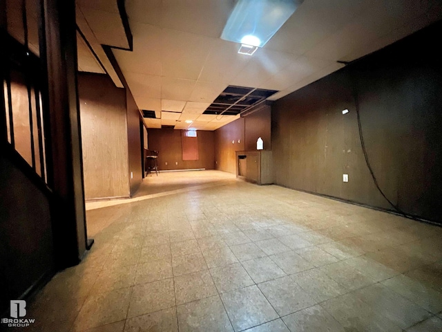 basement with a paneled ceiling