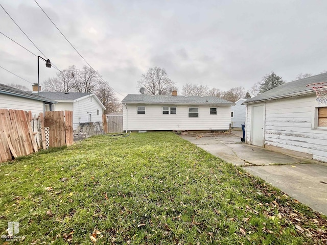 rear view of house featuring a yard