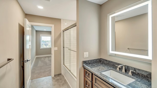 bathroom featuring baseboards, shower / bath combination with glass door, tile patterned flooring, vanity, and recessed lighting