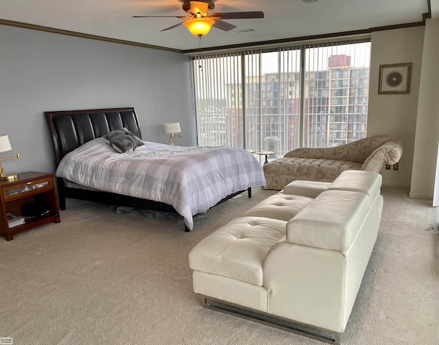 carpeted bedroom featuring ceiling fan and ornamental molding