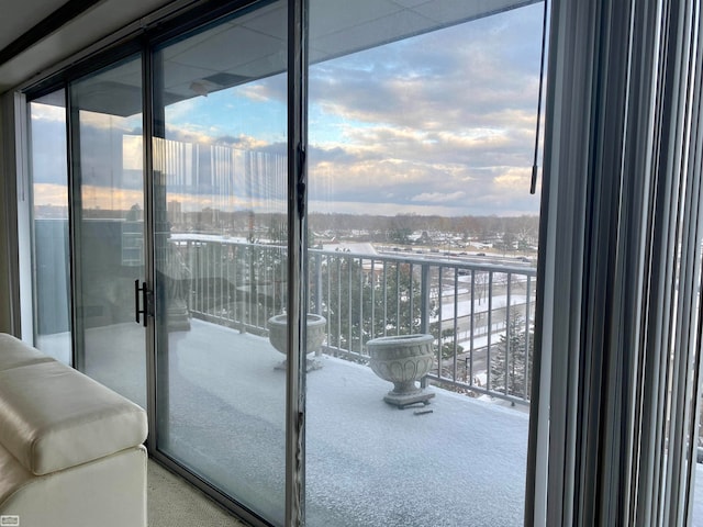 view of snow covered back of property