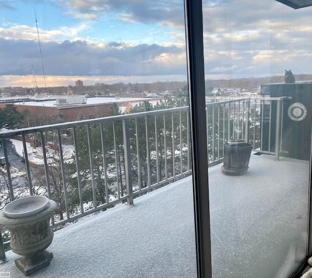 view of snow covered back of property