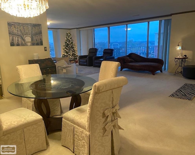 dining space with a notable chandelier, light colored carpet, and a wall of windows