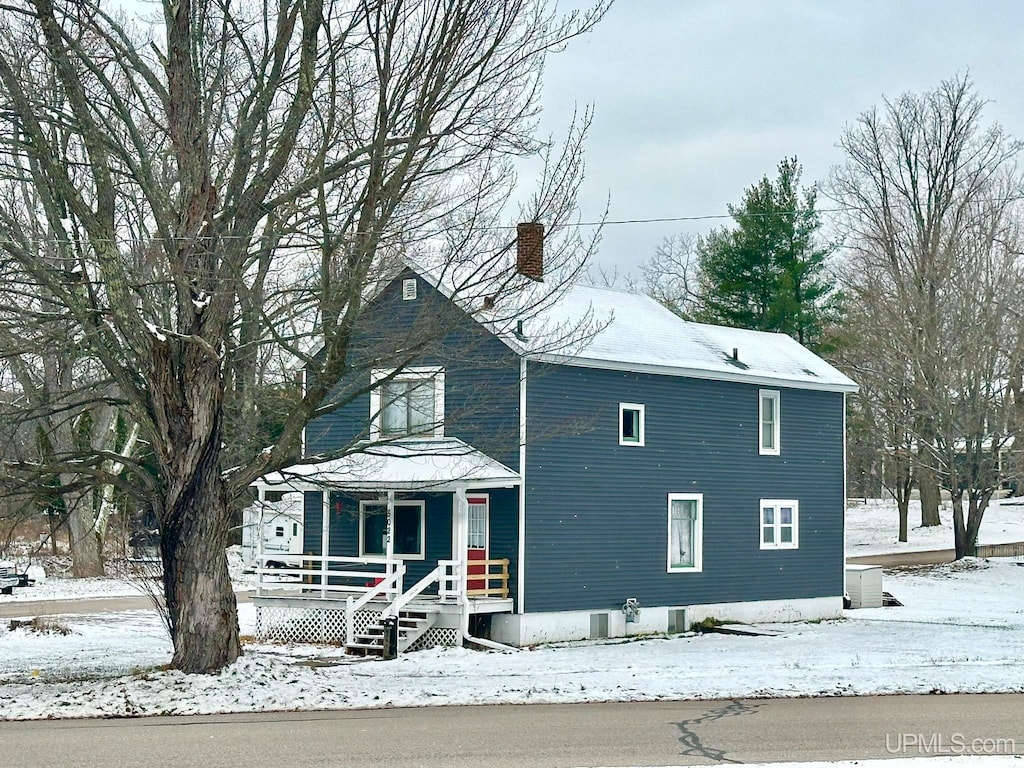 view of snow covered exterior featuring a porch