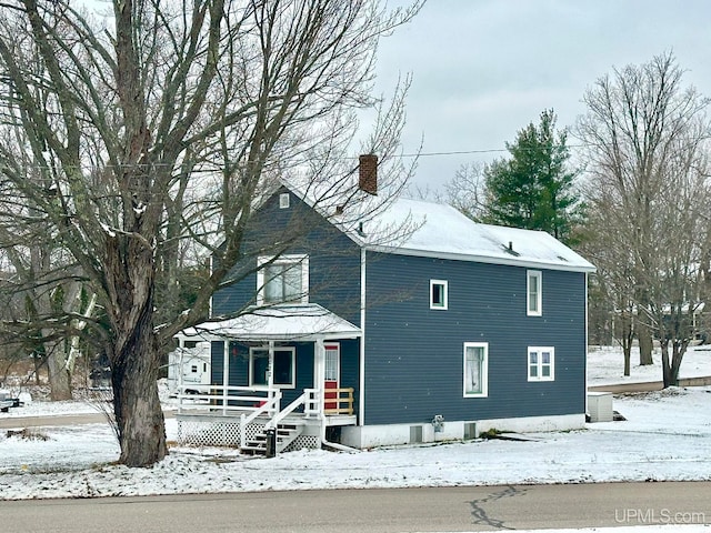 view of snow covered exterior featuring a porch