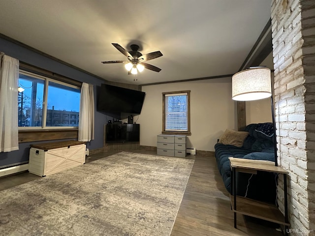 living room with ceiling fan, ornamental molding, dark wood-type flooring, and a baseboard radiator