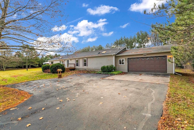 ranch-style home with a front lawn and a garage