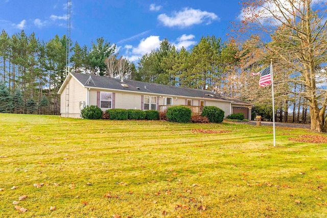 ranch-style house with a garage and a front lawn