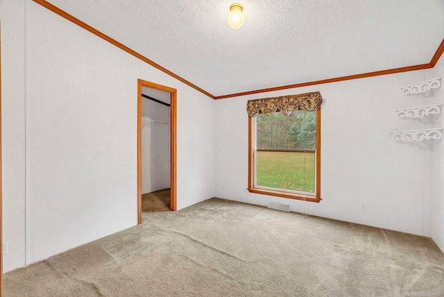 unfurnished bedroom featuring light carpet, crown molding, vaulted ceiling, a textured ceiling, and a closet