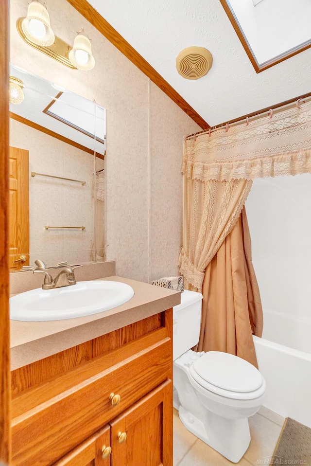 full bathroom with tile patterned flooring, toilet, shower / bath combo with shower curtain, vanity, and ornamental molding