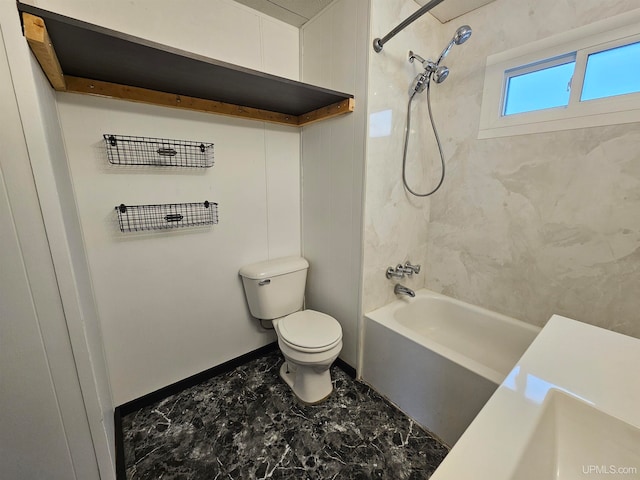 bathroom featuring tiled shower / bath combo and toilet