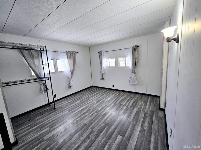 interior space with dark hardwood / wood-style flooring and a wealth of natural light