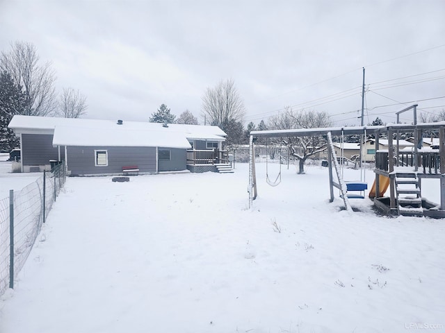 snowy yard with a wooden deck