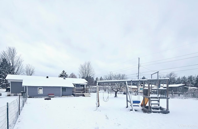 snowy yard with a wooden deck