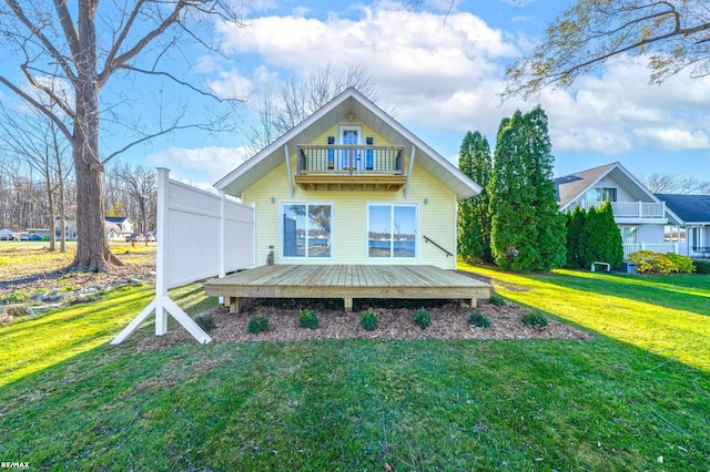 back of property featuring a lawn and a balcony