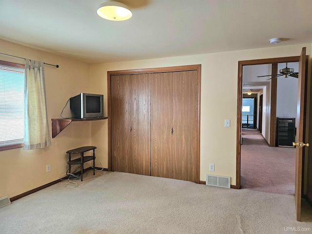 bedroom featuring carpet flooring, a closet, and beverage cooler