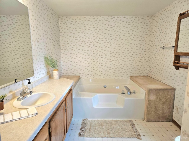 bathroom with tile patterned floors, a bathtub, and vanity