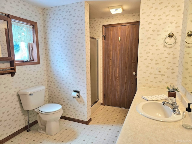 bathroom with tile patterned flooring, vanity, toilet, and a shower with shower door