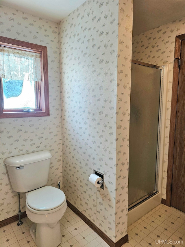 bathroom featuring toilet, tile patterned flooring, and walk in shower