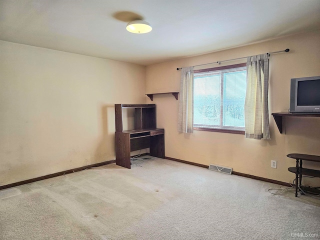 miscellaneous room with light colored carpet