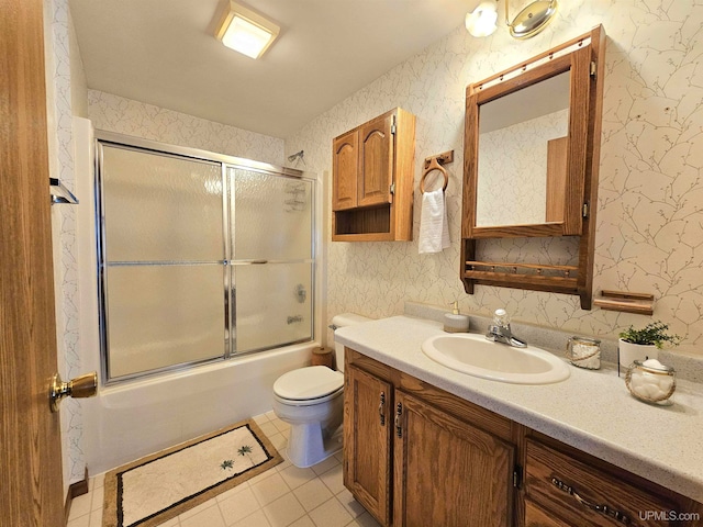 full bathroom featuring tile patterned flooring, vanity, toilet, and shower / bath combination with glass door