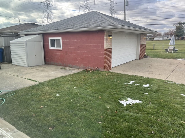 garage featuring a lawn