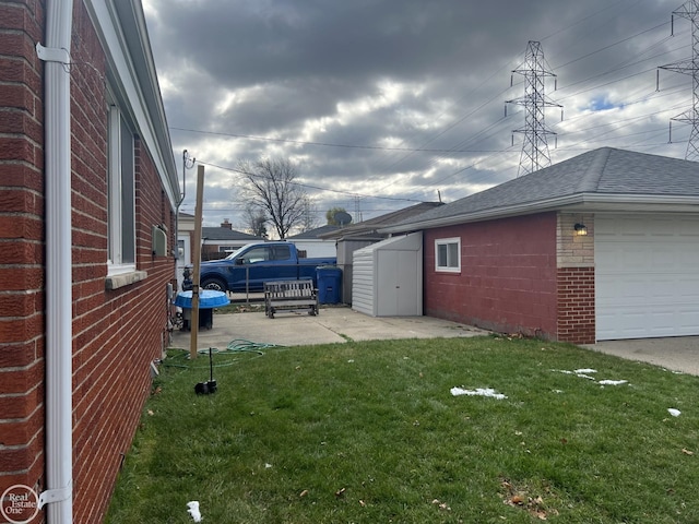 view of yard featuring a garage and a storage shed