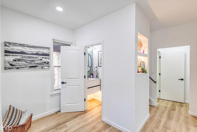 hall with light hardwood / wood-style flooring