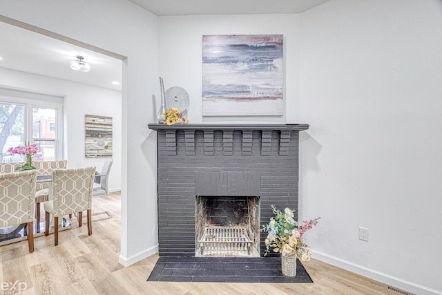 room details with a fireplace and hardwood / wood-style floors