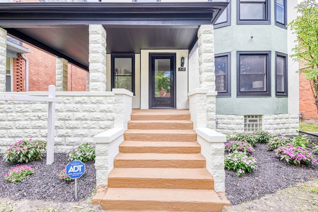 view of exterior entry with a porch