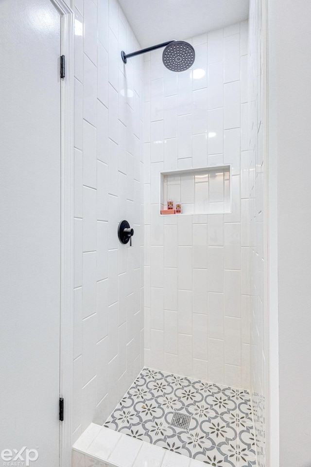 bathroom with tiled shower