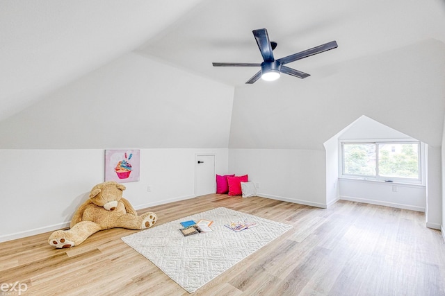 game room with ceiling fan, lofted ceiling, and light hardwood / wood-style flooring