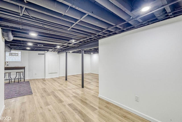 basement with hardwood / wood-style floors